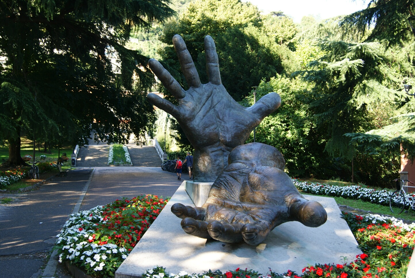 Ciekawa rzeźba w kształcie dłoni w parku, przed dworcem kolejowym w Como