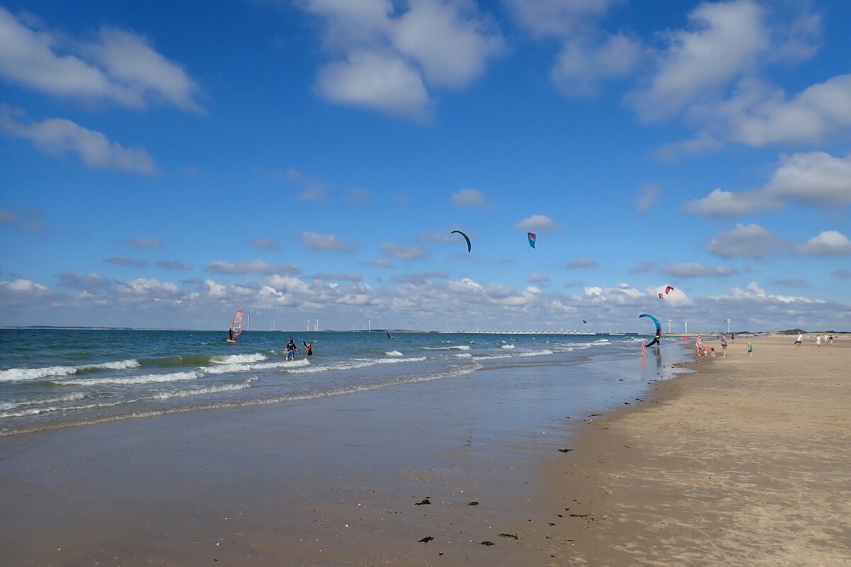 beach with kite surfers